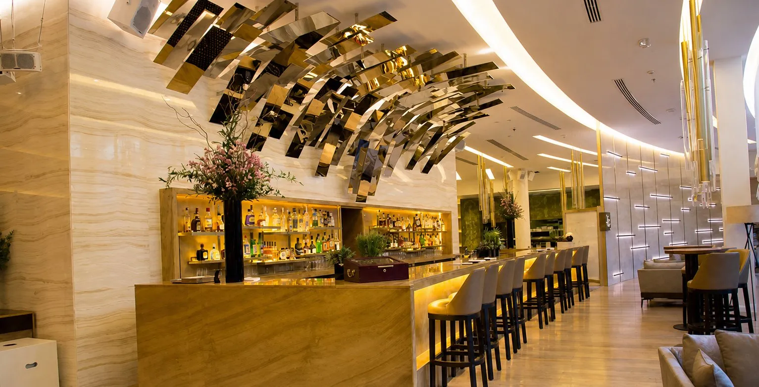 Bar with a sculptural ceiling and back-lit shelving