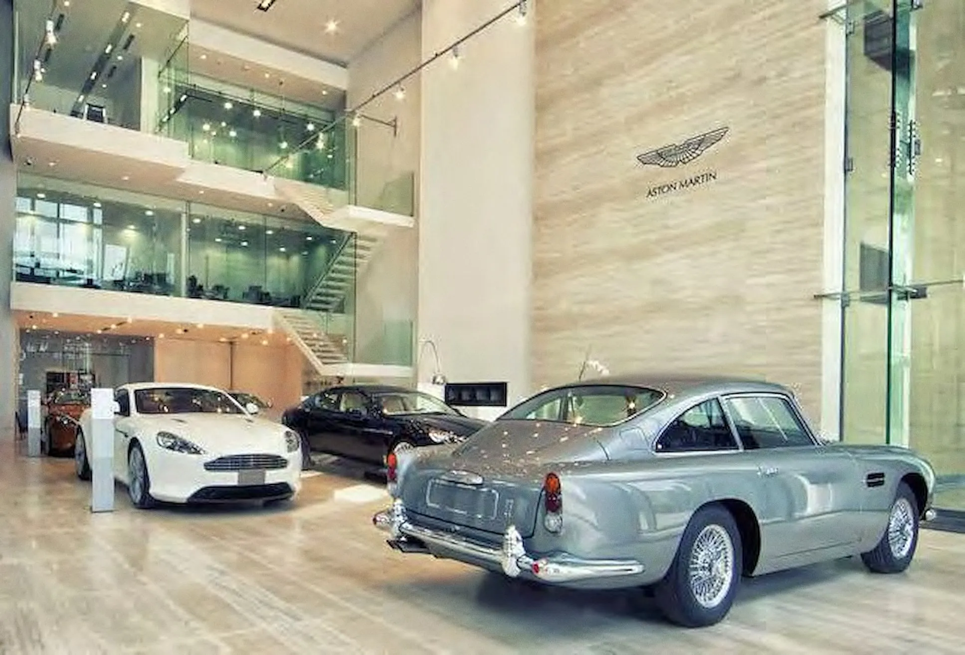 Classic and new Aston Martin cars on the showroom floor