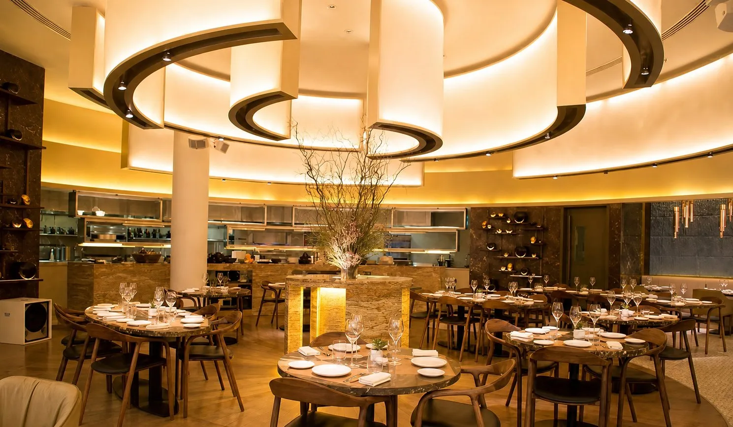 Dining room with layered circular ceiling rings and warm lighting