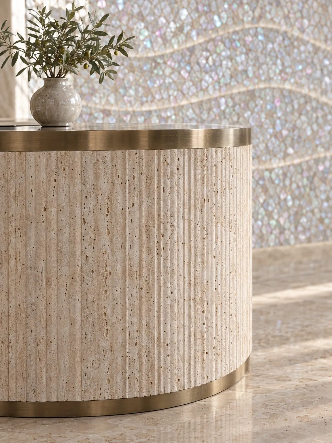 Detail of the fluted travertine reception desk with a brass trim