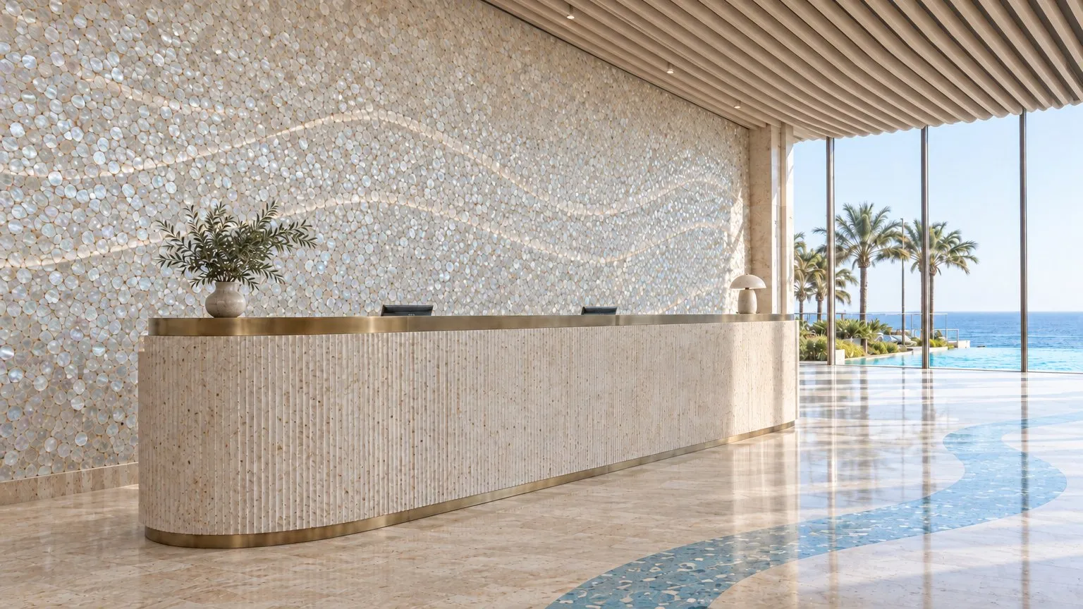 Reception desk in fluted travertine with a brass band, in front of a mother-of-pearl wall